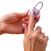 Load image into Gallery viewer, A pair of hands holding and unlocking the rose gold benji lock with the right hand index finger print.