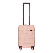 Load image into Gallery viewer, Front view of the pearl pink hard shell suitcase with black accents. The panel has a textured wave lines design, and a small black circular logo at the top right. The telescopic handle is pulled up.