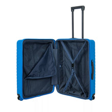 Load image into Gallery viewer, Internal view of the electric blue hard shell suitcase with black accents. The front panel side features a zipper-closing compartment, and the back panel side a set of straps to hold contents in place. The telescopic handle is fully retracted.
