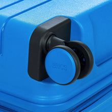 Load image into Gallery viewer, Close up to a spinner wheel on the electric blue suitcase.