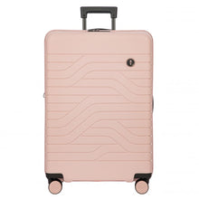 Load image into Gallery viewer, Front view of the pearl pink hard shell suitcase with black accents. The panel has a textured wave lines design, and a small black circular logo at the top right. The telescopic handle is pulled up.