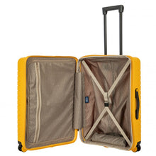 Load image into Gallery viewer, Internal view of the mango yellow hard shell suitcase with black accents. The fabric lining is light brown. The front panel's side has a zipper-closing compartment. The back panel's side has a set of strips to hold contents in place.