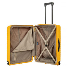 Load image into Gallery viewer, Internal view of the mango yellow hard shell suitcase with black accents. The fabric lining is light brown. The front panel's side has a zipper-closing compartment, shown partly opened. The back panel's side has a set of strips to hold contents in place.