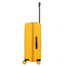 Load image into Gallery viewer, Side view of the mango yellow hard shell suitcase with black accents. A black handle is placed for easy grabbing.