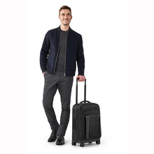 Load image into Gallery viewer, Briggs & Riley ZDX 22" Carry-On Expandable Spinner - Black
Image of Model with front Angled View of ZDX Carry-On Spinner
Dimensions:  22 x 14 x 9" (exp. to 11")
Weight:           7.4 lbs.