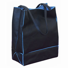 Load image into Gallery viewer, Angled front view of the black tote bag with blue accents.