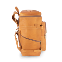Load image into Gallery viewer, DayTrekr Top Load Leather Gear Backpack - Tan
Image of Left-Facing Side Panel View.  Also showing side zippered pocket and two cinch straps should you wish to attach a blanket.
Dimensions:  16 x 12 x 7.5"