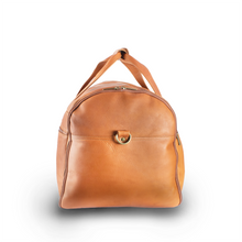 Load image into Gallery viewer, DayTrekr Leather Deluxe Duffel - Tan
Image of End Panel View, inclusive of antique brass shoulder strap D-Ring
Dimensions:  22 x 12 x 12"