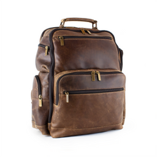 Load image into Gallery viewer, DayTrekr Distressed Leather Backpack - Brown
Image of Front Angled View with antique brass hardware
Dimensions: 15.5"W x 17"H x 8"D