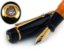 Load image into Gallery viewer, Angled close up of the fountain pen with the cap behind it. A top close up to the cap is shown above, featuring the diamond within a golden ring.
