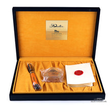 Load image into Gallery viewer, The fountain pen, ink bottle, and booklet arranged inside the presentation box.