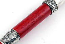 Load image into Gallery viewer, Close up to the red barrel of the pen with engraved Delta logo and text: GAIUS JULIUS CAESAR, LIMITED EDITION
