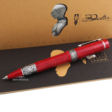 Load image into Gallery viewer, Side view of the red rollerball arranged with the booklet and presentation box.