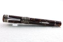 Load image into Gallery viewer, Front view of the fountain pen resting on a small stand.