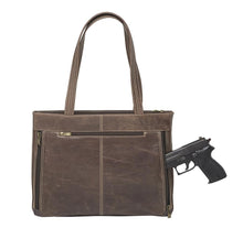 Load image into Gallery viewer, The brown distressed leather purse with a pistol near the compartment.
