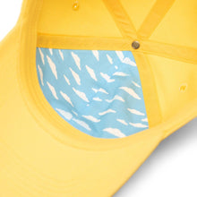 Load image into Gallery viewer, Angled interior view of the Lisa Simpson Sylas Cap. It features a blue piece of fabric lining with white clouds pattern.