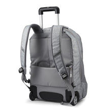 Load image into Gallery viewer, Angled back panel view of the silver backpack with the shoulder straps and telescopic handle extended.