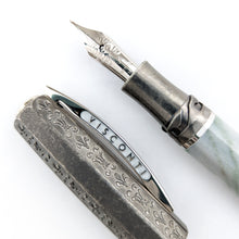 Load image into Gallery viewer, Close up to the Visconti Il Magnifico Green Marble Fountain Pen nib and cap. The nib is made of 18kt white gold and has a series of engraved decorations. The side of the cap's clip has the word VISCONTI engraved on it.