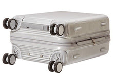 Load image into Gallery viewer, Angled bottom view of the suitcase. It features four spinner wheels, a grip handle on the bottom, and four stub legs on the side panel.