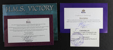 Load image into Gallery viewer, The certificates and booklet arranged on a black background.