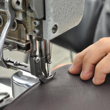 Load image into Gallery viewer, Close up to a leather sowing machine, stitching on brown leather.