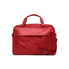 Load image into Gallery viewer, Front view of the red duffle bag with the shoulder strap across the front.
