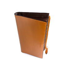 Load image into Gallery viewer, Angled front view of the toffee clutch wallet with the word LODIS embossed.