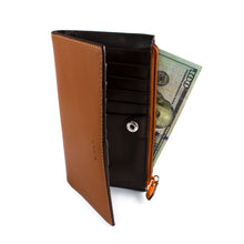 Load image into Gallery viewer, Angled view of the toffee leather wallet with a 100 dollar bill peeking from the zipper compartment.