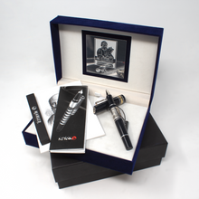 Load image into Gallery viewer, The black rollerball arranged with the presentation box, packaging, and booklets.