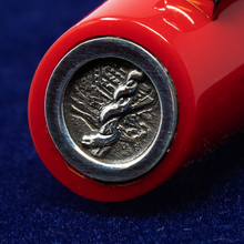 Load image into Gallery viewer, Close up to the medal at the top of the cap, engraved with the Rod of Asclepius