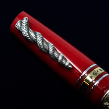 Load image into Gallery viewer, Close up to the cap's clip, in the shape of the Rod of Asclepius.