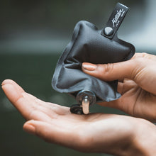 Load image into Gallery viewer, A pair of hands squeezing soap from the toiletry bottle .