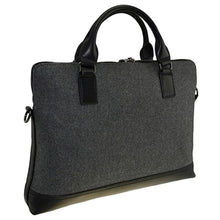 Load image into Gallery viewer, Angled back panel view of the briefcase with the shoulder strap detached.