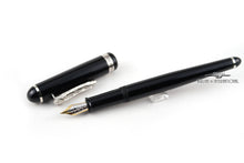 Load image into Gallery viewer, Angled view of the black fountain pen with the cap next to it.