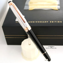 Load image into Gallery viewer, The fountain pen with the cap on. Set on a pen stand with the presentation box behind it.