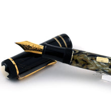 Load image into Gallery viewer, Close up to the pen's grip section resting on the cap.