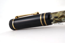 Load image into Gallery viewer, Angled close up to the cap's engraved edition number.