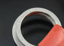 Load image into Gallery viewer, Close up to the engraved key ring with Montblanc logo.