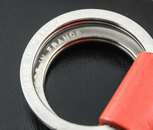Load image into Gallery viewer, Close up to the key rings with engraved text Made in France.