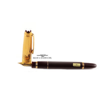 Load image into Gallery viewer, The fountain pen with the cap next to the nib on a white background.