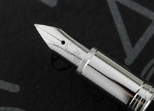 Load image into Gallery viewer, Close up to the fountain pen nib with the engraved Montblanc logo and 14K gold hallmarks.