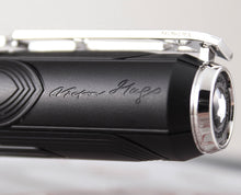 Load image into Gallery viewer, Close up to the engraved Victor Hugo signature on the top side of the pen.