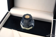 Load image into Gallery viewer, Close up to the sealed ink bottle with decorated medal on the cap.