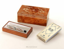 Load image into Gallery viewer, The fountain pen arranged with the presentation box and booklet on a white background.
