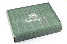 Load image into Gallery viewer, Angled view of the green card stock box. It has scuff marks on the corners.