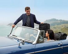 Load image into Gallery viewer, Briggs & Riley Baseline Expandable Cabin Bag 
Image of couple in luxury convertible top vehicle packed with two pieces from the Briggs & Riley Baseline Collection
Height	   Width	     Depth	    Weight
US	11 in.	17 in.	8 in.	        3 lbs.
EU	27.9 cm	43.2 cm	20.3 cm	1.4 kg