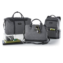 Load image into Gallery viewer, Group shot of three different bags with some accessories on a white background. Each bag is made of gray fabric with black leather trims. The left bag is a duffle bag, the center bag is a laptop bag with a leather strap, and the right one is a backpack with compartment pockets.