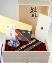 Load image into Gallery viewer, The fountain pen arranged with the presentation box, ink bottle, eye dropper, and certificates.