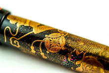 Load image into Gallery viewer, Close up to the golden decorations on the pen barrel.