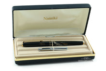 Load image into Gallery viewer, The fountain pen resting with the ink pouch inside the case.